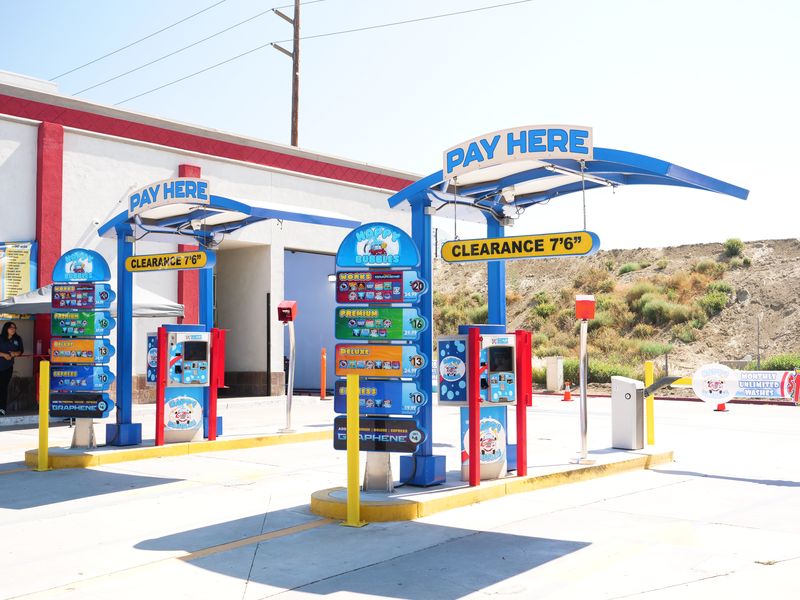 Two pay stations under blue Pay Here arches
