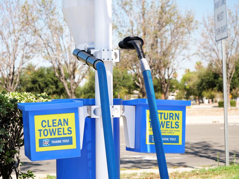 Blue Clean Towels and Return Towels bins next to a vacuum station